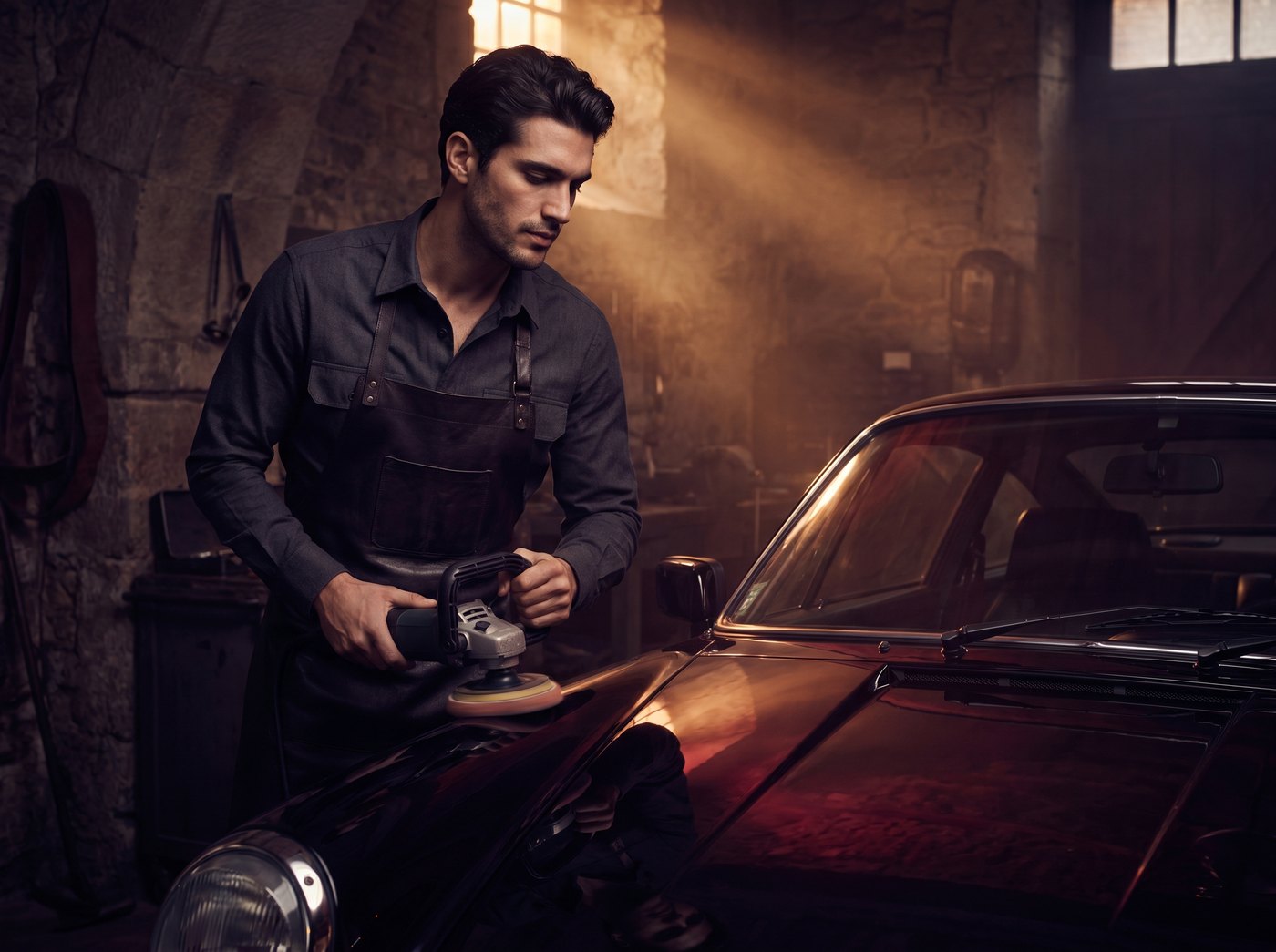 A detailer polishing a black sports car